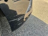 a close up of a car ' s fender on the side of the road