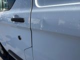 a white van that is parked on the side of the road