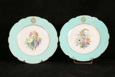 two plates with floral designs on them on a black background
