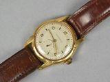 a close up of a wrist watch with a brown strap