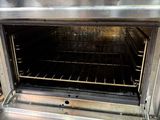 a silver oven with four burners on the inside of it