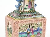 a vase with a painting on it sitting on a table