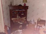 a messy room with a bed, desk, chair, and a dresser