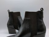 a close up of a pair of black boots on a white background