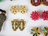 many different types of jewelry on a white surface