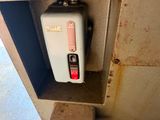 a water heater that is attached to the side of a wall