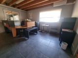 an image of a kitchen with a table and a refrigerator
