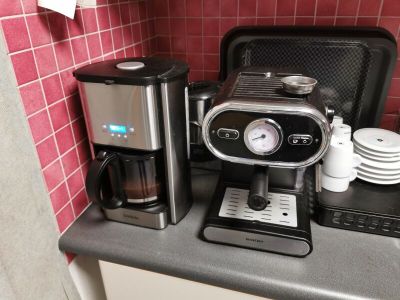 a coffee maker and a coffee maker on a kitchen counter