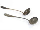 two spoons that are sitting next to each other on a table