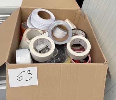 many rolls of tape in a cardboard box on the floor