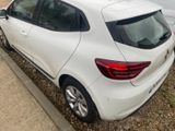 a white car that is parked on the side of the road