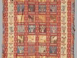 a red and yellow rug with a pattern of animals on it