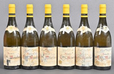 six bottles of wine lined up in a row on a table