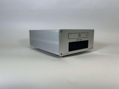 a close up of a silver electronic device on a white surface
