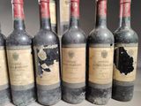 several bottles of wine are lined up on a table