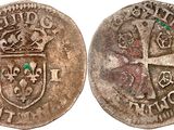 a silver coin with a cross and a crown on it