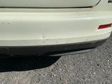 a close up of a car ' s rear bumper and tail light