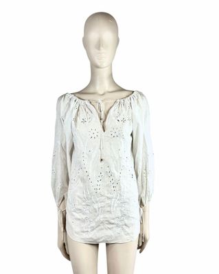 the mannequin is wearing a white dress with a long sleeve