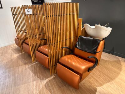a chair and a sink in a room with a bamboo screen