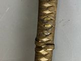 a close up of a knife on a wall