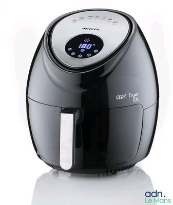the air fryer is black and white with a digital clock on it