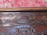 a wooden table with a red and white wallpaper behind it