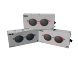 three pairs of sunglasses are sitting in a box on a white surface