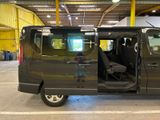 a black van with its doors open in a garage