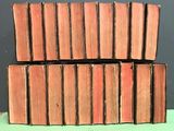 several old books stacked on top of each other on a table