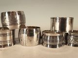 many silver cups sitting on a table next to each other