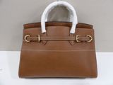 a brown leather handbag with a white fur lined handle