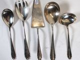 five spoons and two spoon spoons on a white surface