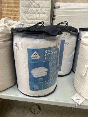 several rolls of toilet paper are stacked on a shelf in a store