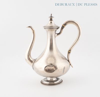 a silver tea pot sitting on a white surface