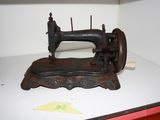 an old sewing machine sitting on a shelf in a room