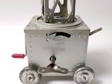 a small metal object that is sitting on top of a cart