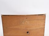 an old wooden box sitting on top of a white surface
