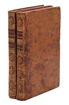 un vieux livre à la couverture brune posé sur une surface blanche