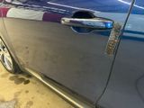 a close up of a car door handle with a sticker on it