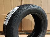 tire on the floor in front of a cardboard box and cardboard wall