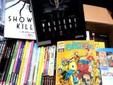 a box full of comics and books on a table