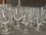a lot of wine glasses sitting on a table