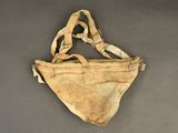 an old bag with a strap hanging from it ' s side