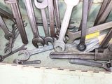 many wrenches and other tools in a box