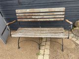 a wooden bench that is sitting in front of a building