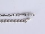 pair of silver chain bracelets on a white surface