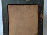 an old wooden picture frame with peeling paint on it