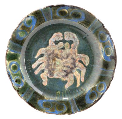 a blue and green plate with a picture of a crab on it