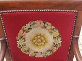 a red chair with a floral design on the back