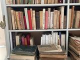 many books on a book shelf in a room